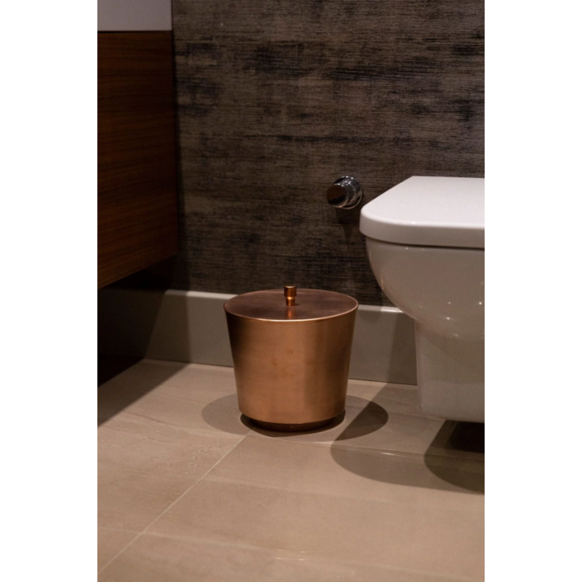 Unique copper waste bin with a sleek, minimalist cube shape for home or office use.