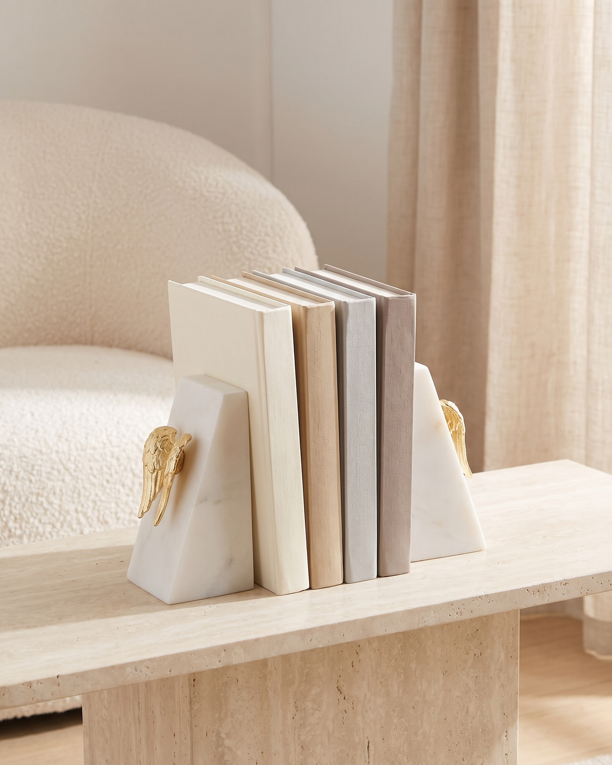 Angel Wing Bookends in White Marble - styled on a travertine console holding plain books