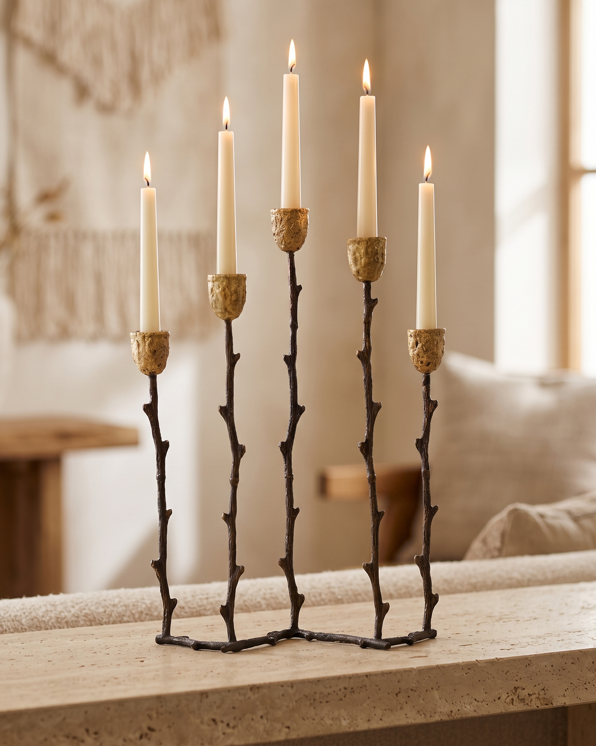 Branch Five-Arm Candelabra in Aged Gold Brass - with lit candles, styled on a warm beige console in a cosy interior