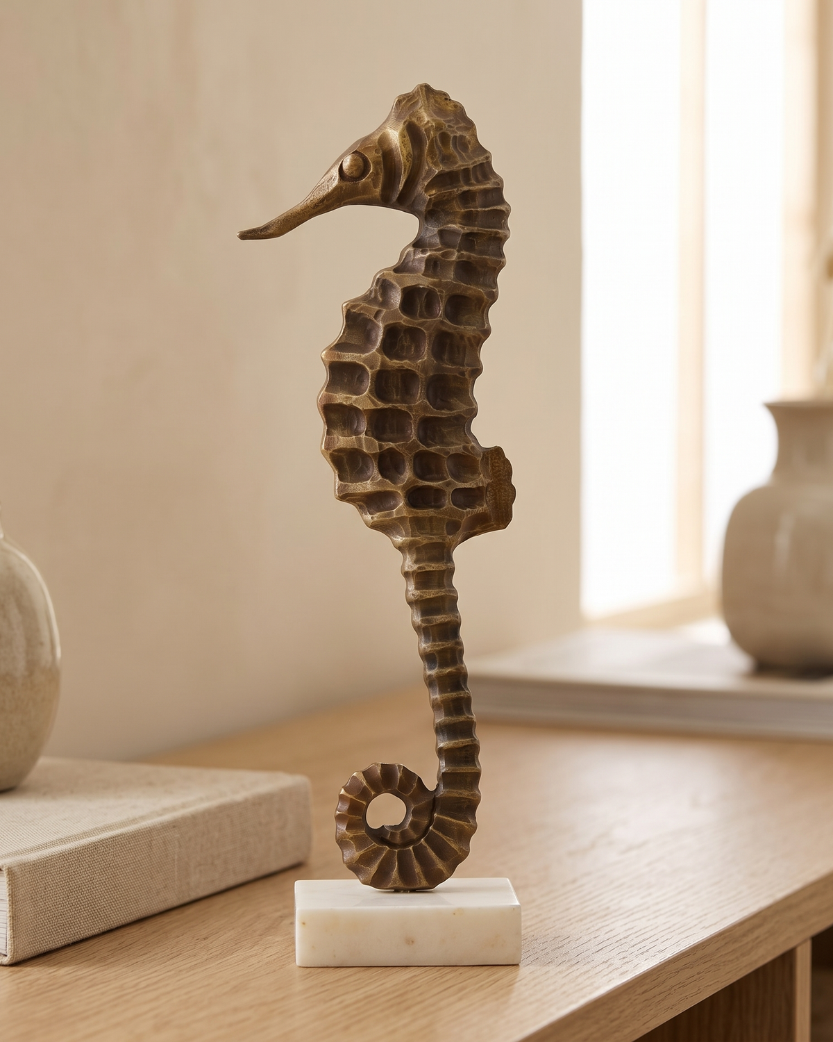 Brass Seahorse Decorative Object Antiqued - styled on a warm beige console in a cosy interior