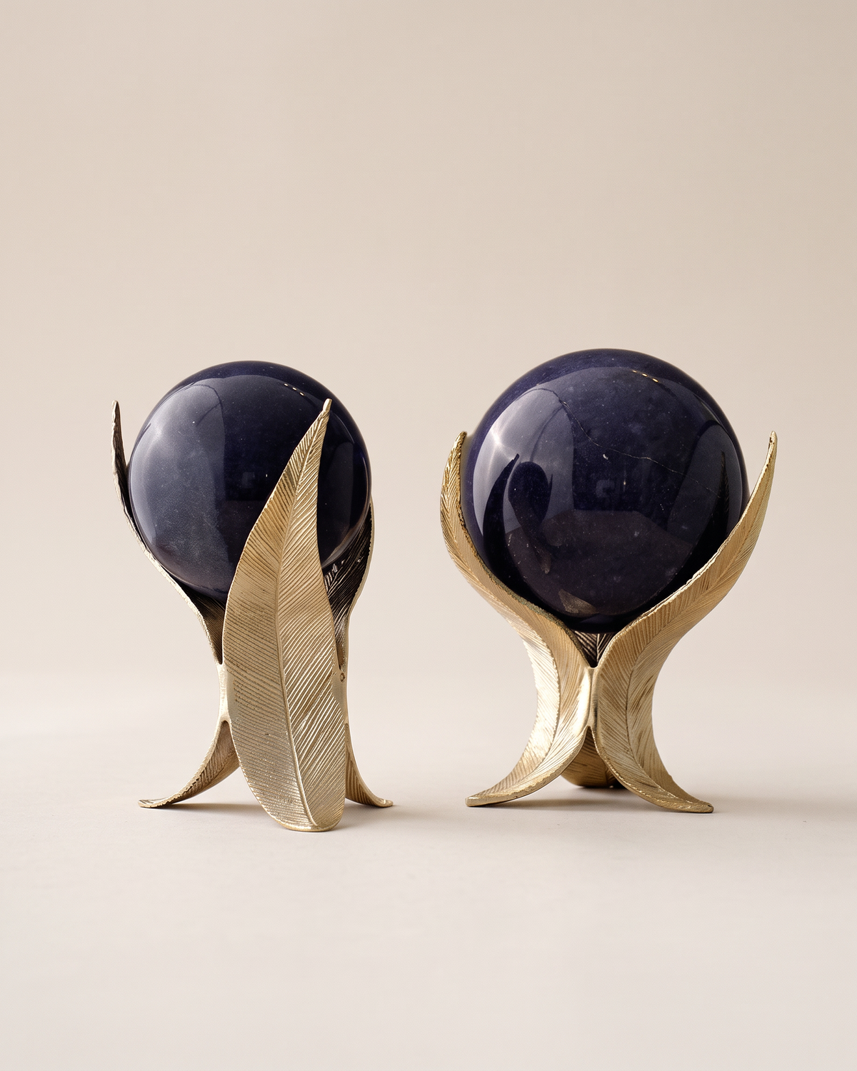Feather Marble Spheres, Gold & Deep Blue (Set of 2) on a warm ivory studio background