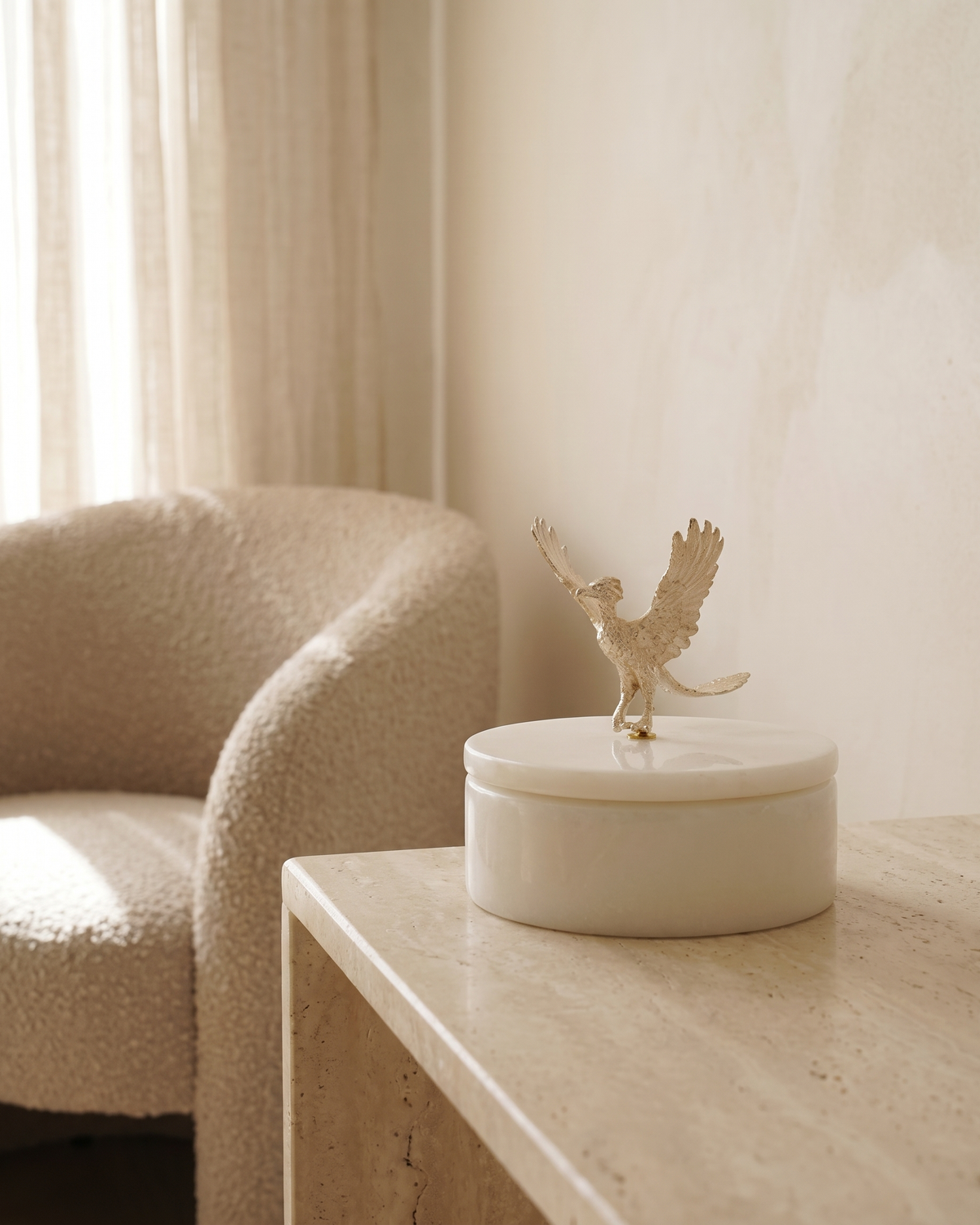 Flying Bird Marble Box with Sculptural Brass Lid - styled on a travertine console in a light interior