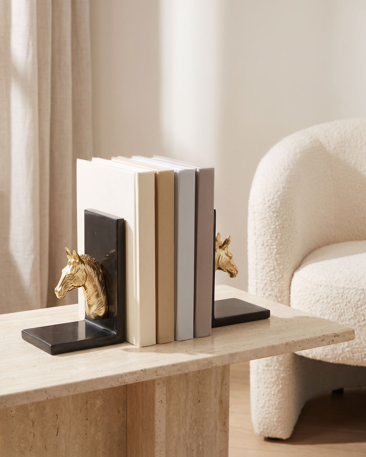 Golden Horse Head Bookends with Black Marble Base - styled on a travertine console holding plain books