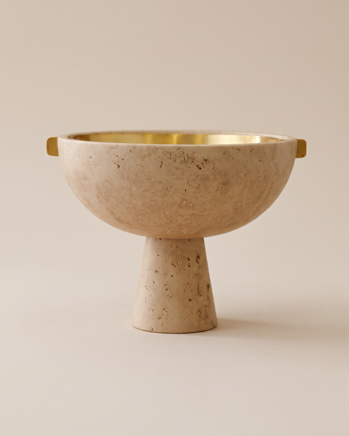 Travertine Pedestal Bowl with Brass Handles (One Piece) on a warm ivory studio background