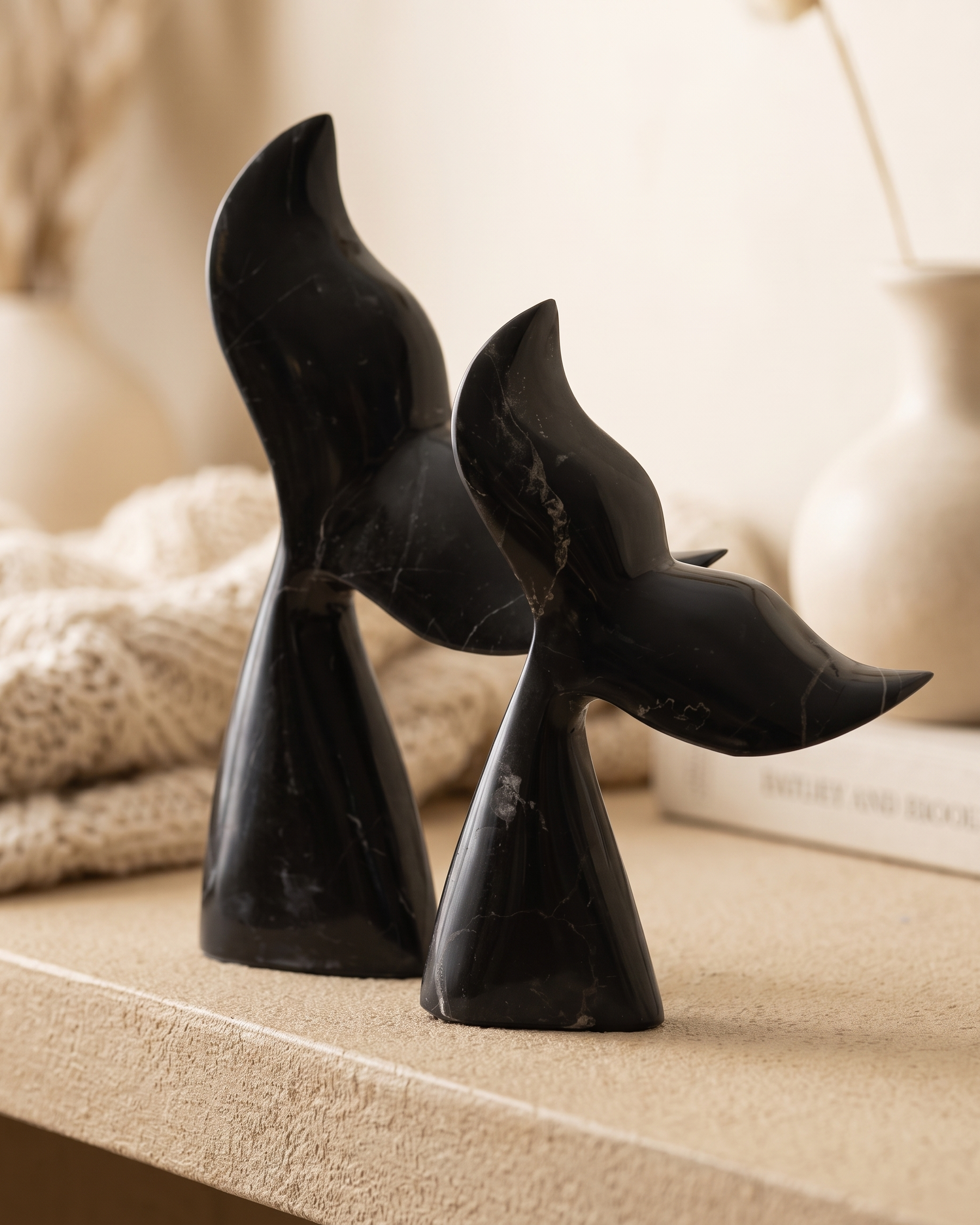 Whale Tail Decorative Object IV - styled on a warm beige console in a cosy interior