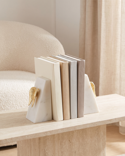 Angel Wing Bookends in White Marble - styled on a travertine console holding plain books