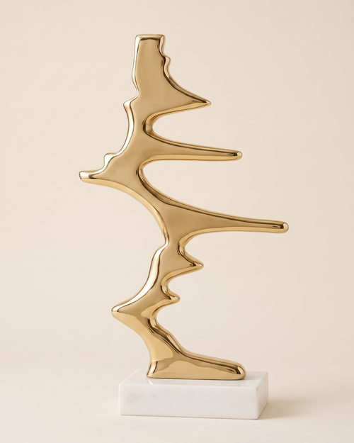 Ban Decorative Object - polished gold brass abstract sculpture on white marble base, ivory studio background