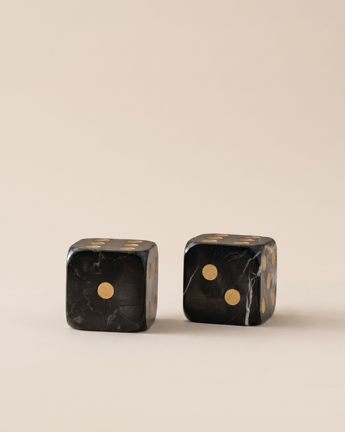 Black Marble Dice Set - two black marble dice with gold inlaid pips, ivory studio background