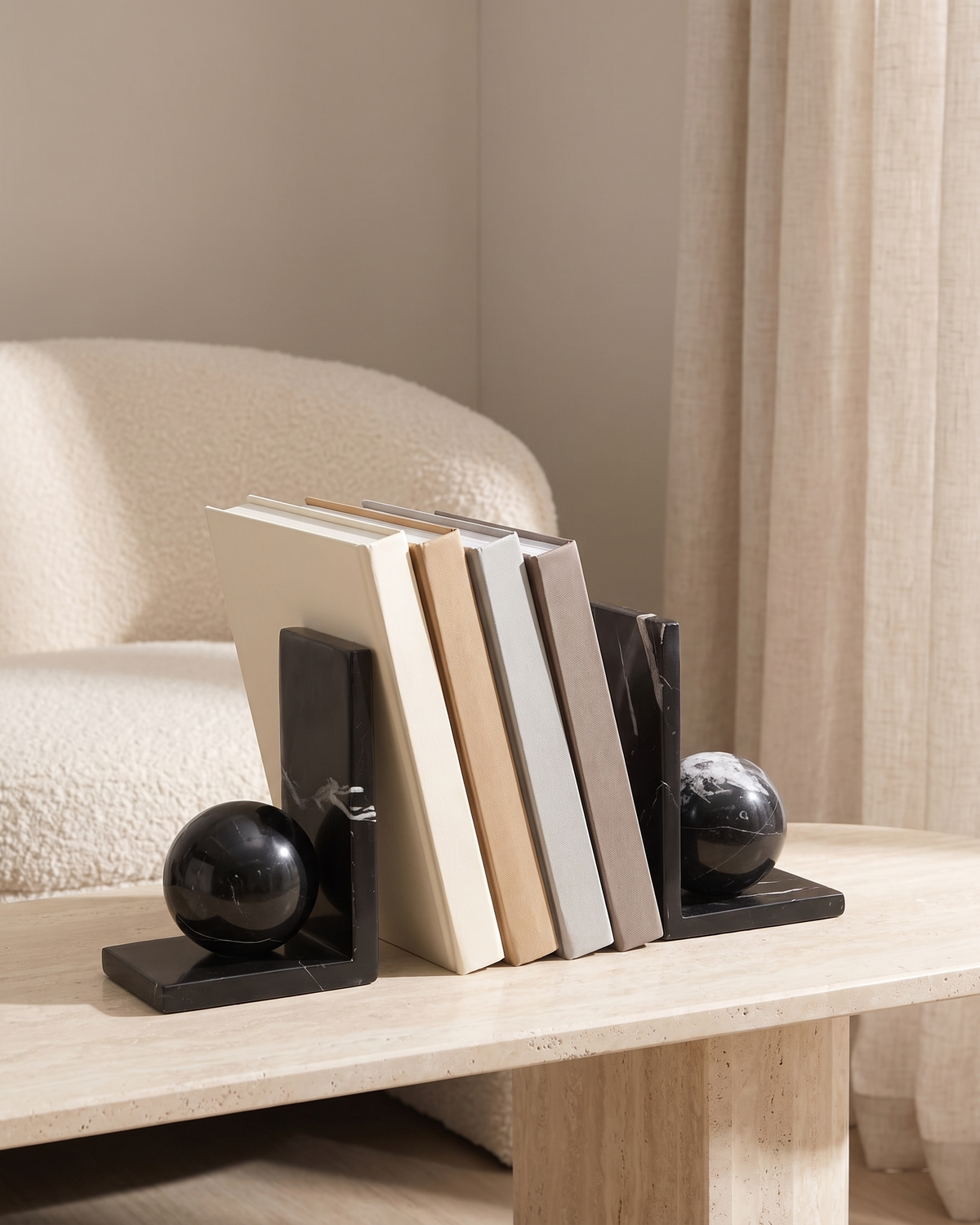 Black Marble Sphere Bookends - styled on a travertine console holding plain books
