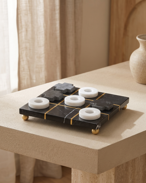 Black and White Marble Tic Tac Toe Game Set - styled on a warm beige console in a cosy interior