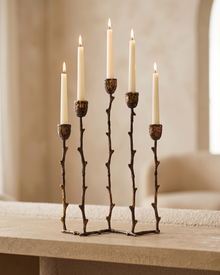 Branch Five-Arm Candelabra in Silvered Brass - with lit candles, styled on a warm beige console in a cosy interior