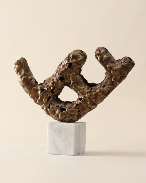 Brass Balance Log Decorative Object II - antiqued bronze eroded branch sculpture on white marble cube, ivory studio background