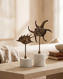 Brass Snail IV - styled on a warm beige console in a cosy interior