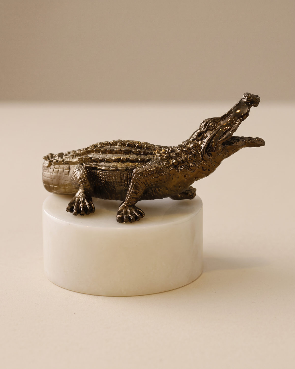 Bronze Crocodile on Marble Base (One Piece) on a warm ivory studio background