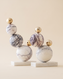 Bubble Decorative Object Lilac II - two stacked lilac veined marble and gold sphere sculptures, ivory studio background