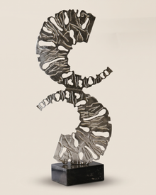 Double XL C-Form Decorative Object Silver - pierced silver double spiral sculpture on black marble cube, ivory studio background