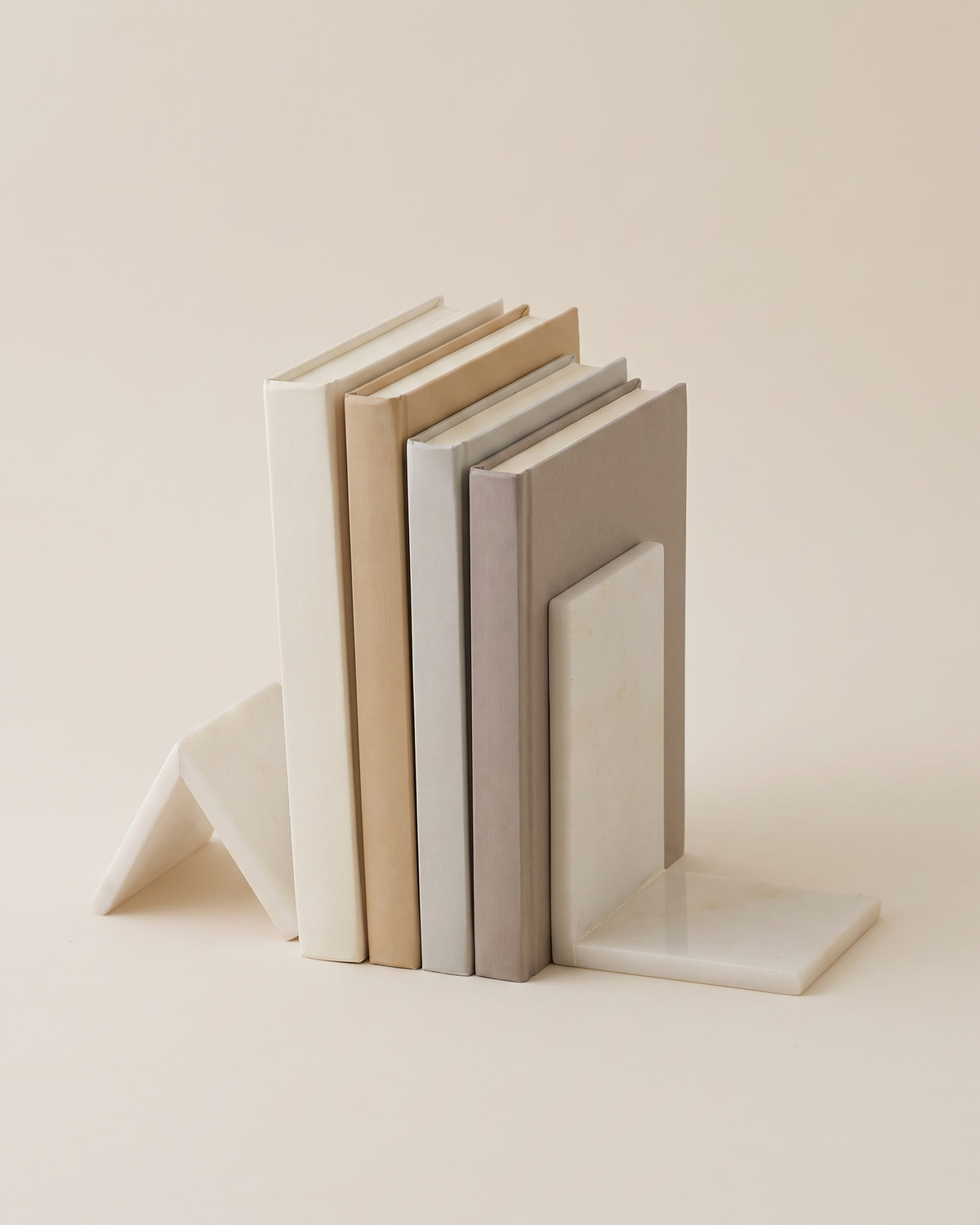 Geometric Marble Bookend Set - studio view on ivory background, holding a row of plain books