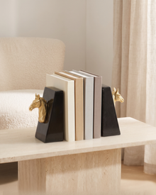 Gold Horse Head Bookends with Black Marble Base - styled on a travertine console holding plain books