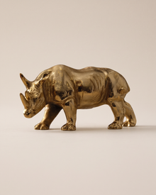 Rhino Sculpture (One Piece) on a warm ivory studio background