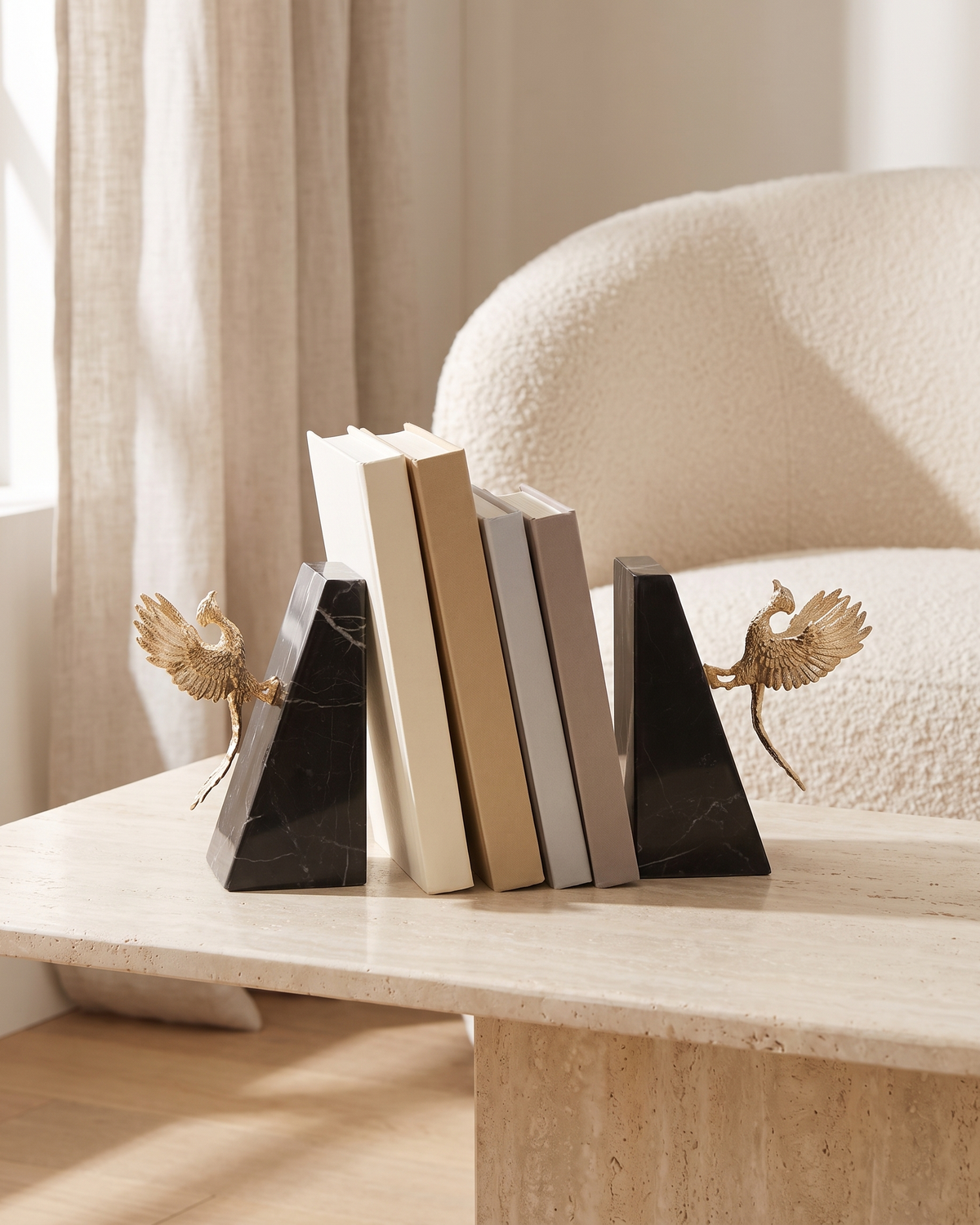 Gold Winged Bird Bookends with Black Marble Base - styled on a travertine console holding plain books