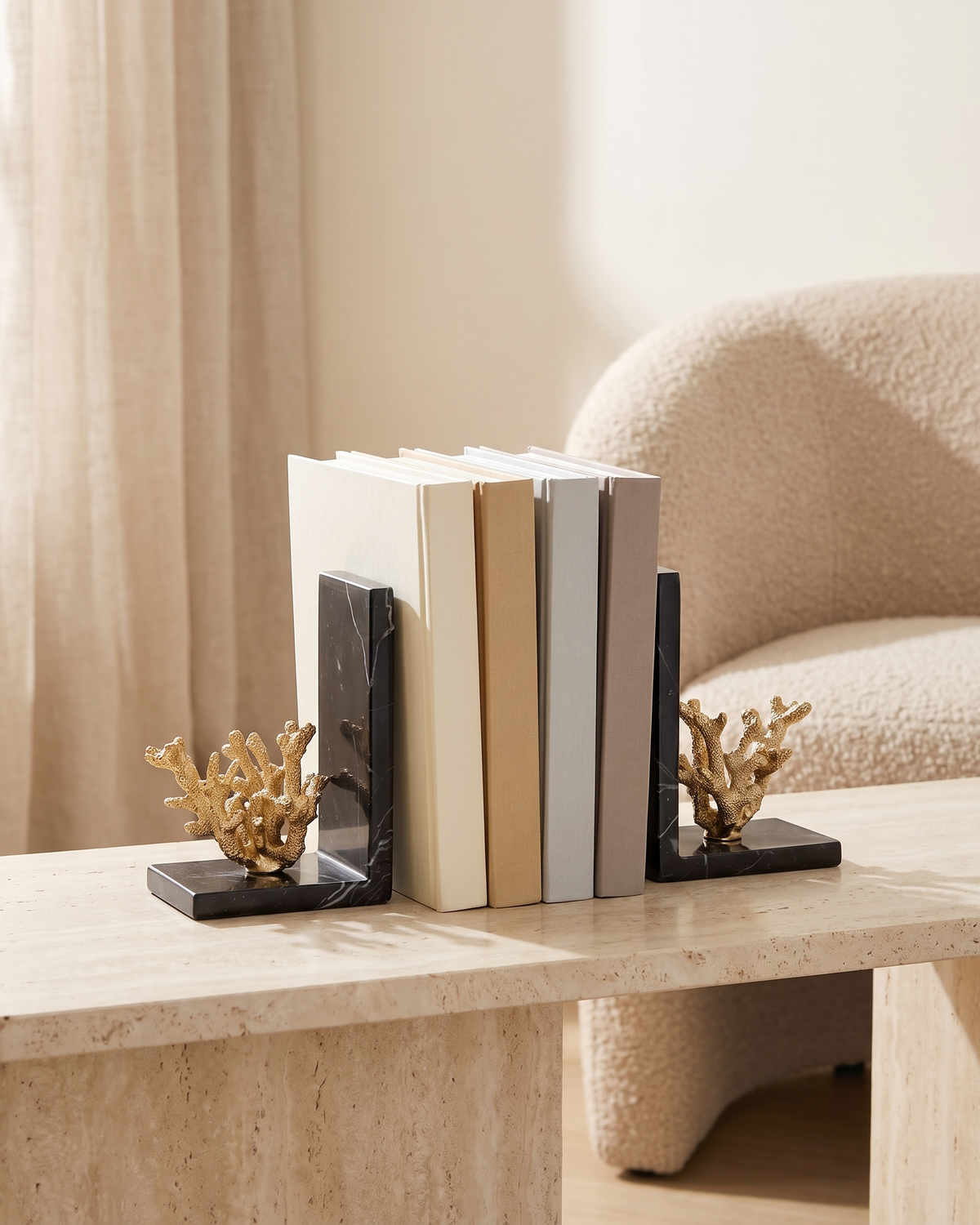 Golden Coral Bookends with Black Marble Base - styled on a travertine console holding plain books
