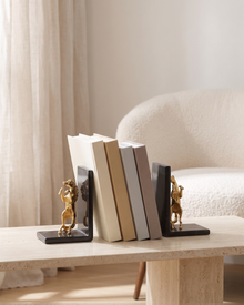Golden Horse Bookends with Black Marble Base - styled on a travertine console holding plain books