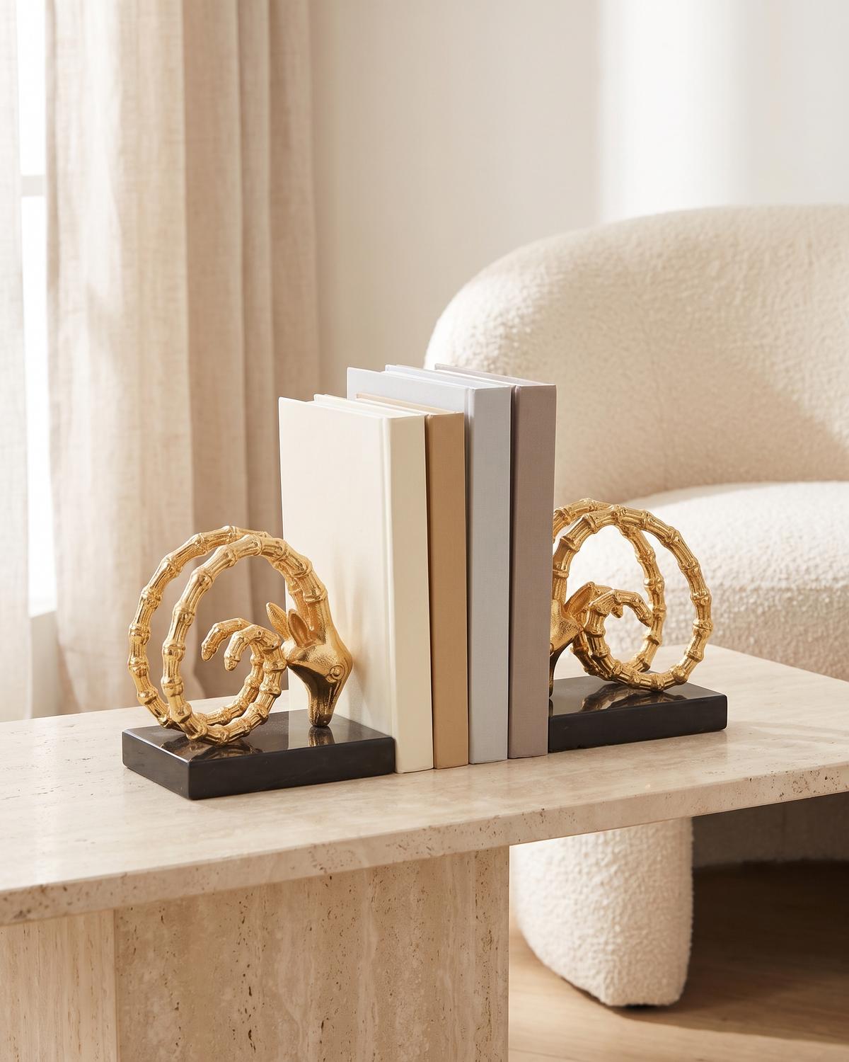 Golden Ram Horn Bookends with Black Marble Base - styled on a travertine console holding plain books