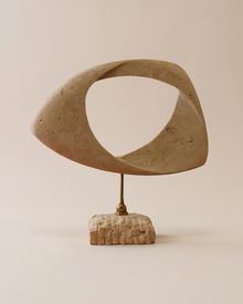Travertine Twisted Ring Sculpture (One Piece) on a warm ivory studio background