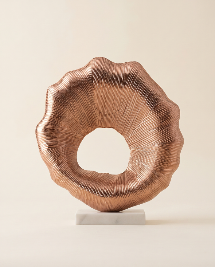 Copper Sunburst Ring Sculpture on White Marble Base