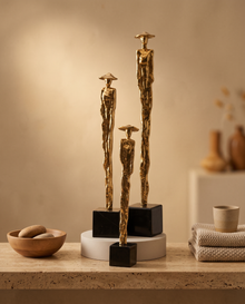 Brass Women with Hats on Cube Pedestal - styled warm beige console scene