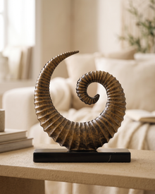 Large Brass Snail - styled on a warm beige console in a cosy interior