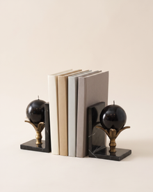 Lotus Sphere Marble Bookends - studio view on ivory background, holding a row of plain books