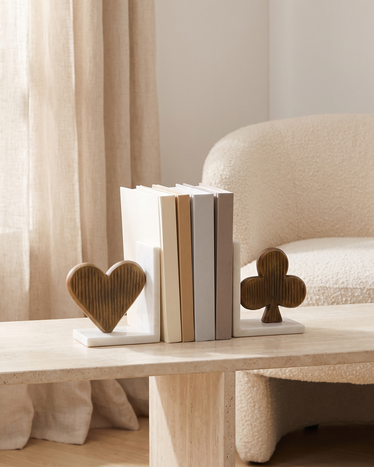 Luxury Spade & Club Bookend Set on Marble Base, Modern Sculptural Shelf Decor - styled on a travertine console holding plain books