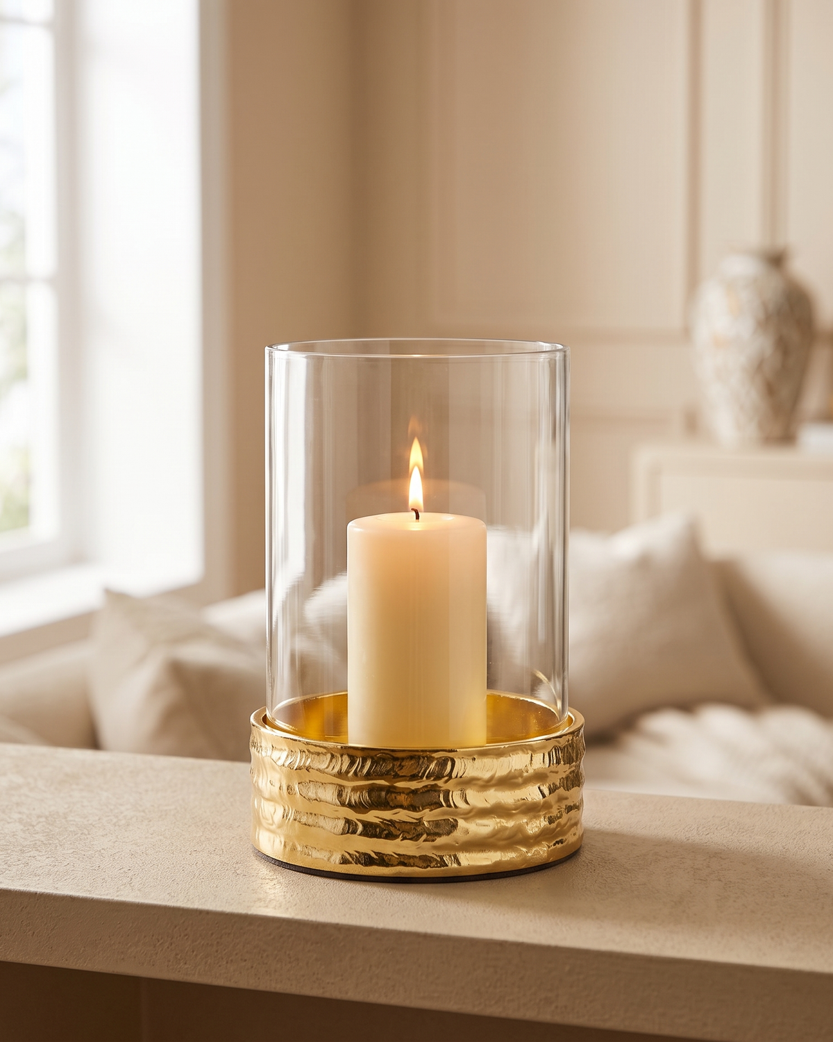 Molten Brass Glass Candlestick I Large - with lit candle, styled on a warm beige console in a cosy interior