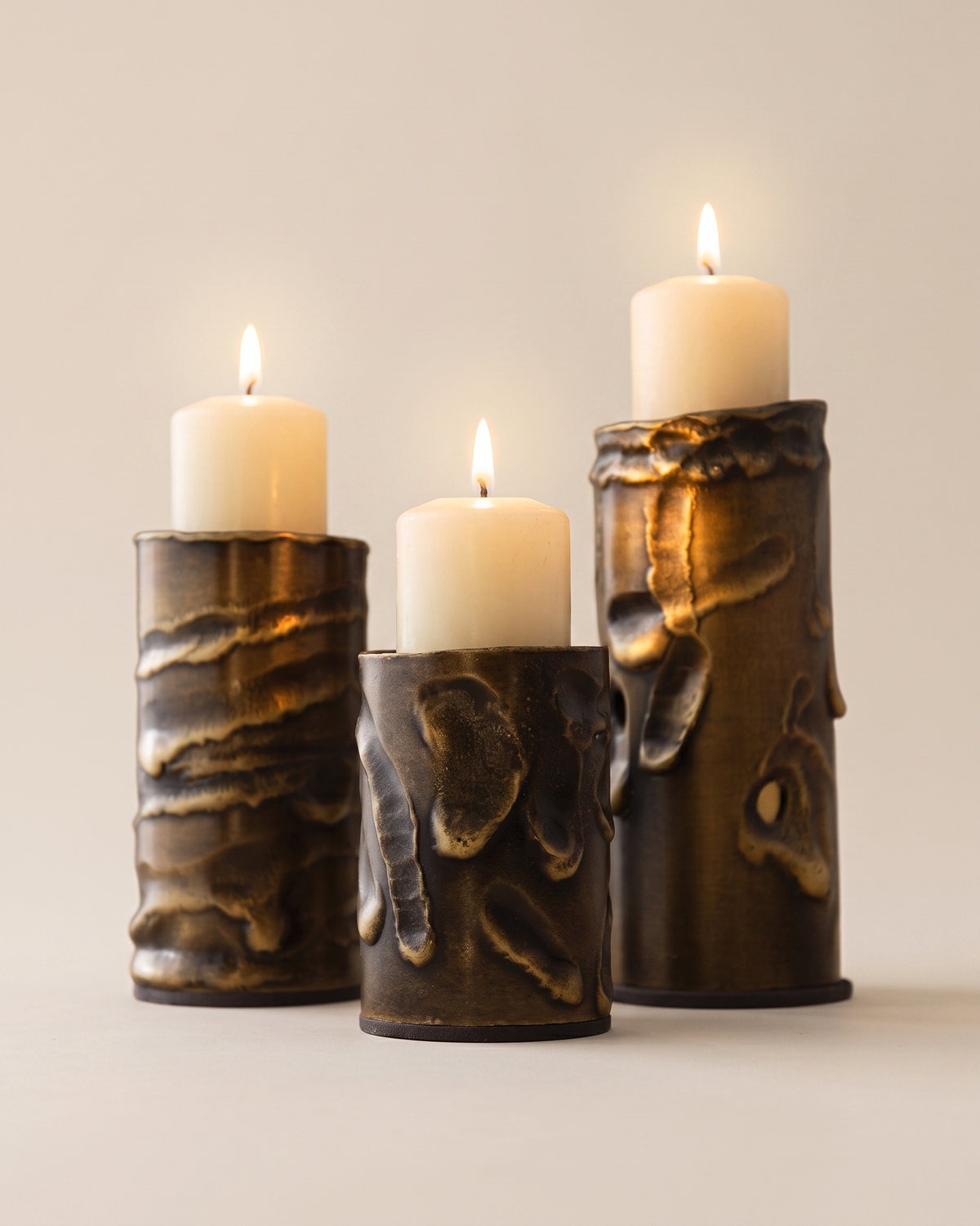 Molten Brass Candle Holder Textured Aged Brass - with lit candles, ivory studio background