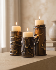 Molten Brass Candle Holder Textured Aged Brass - with lit candles, styled on a warm beige console in a cosy interior