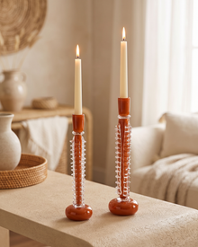 Ridged Glass Candle Holder Medium - with lit candle, styled on a warm beige console in a cosy interior