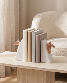 Rose Gold Horse Head Bookends with White Marble Base - styled on a travertine console holding plain books