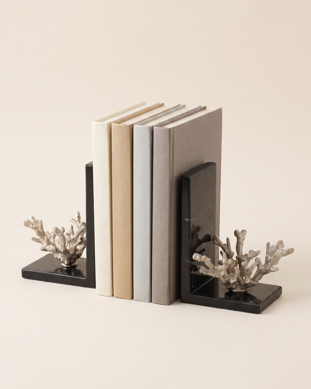 Silver Coral Bookends with Black Marble Base - studio view on ivory background, holding a row of plain books