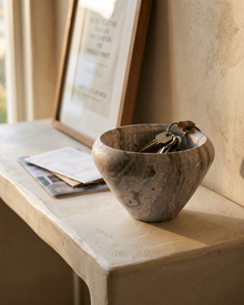 Silver Travertine Balloon Bowl styled in a warm interior setting