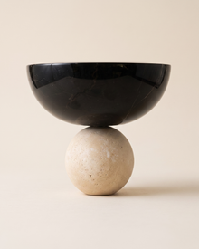 Travertine Bowl with Sphere on a pale ivory studio background