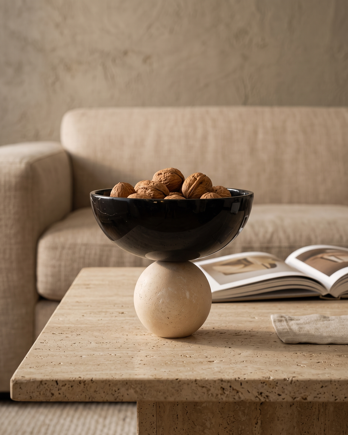 Travertine Bowl with Sphere styled in a warm interior setting