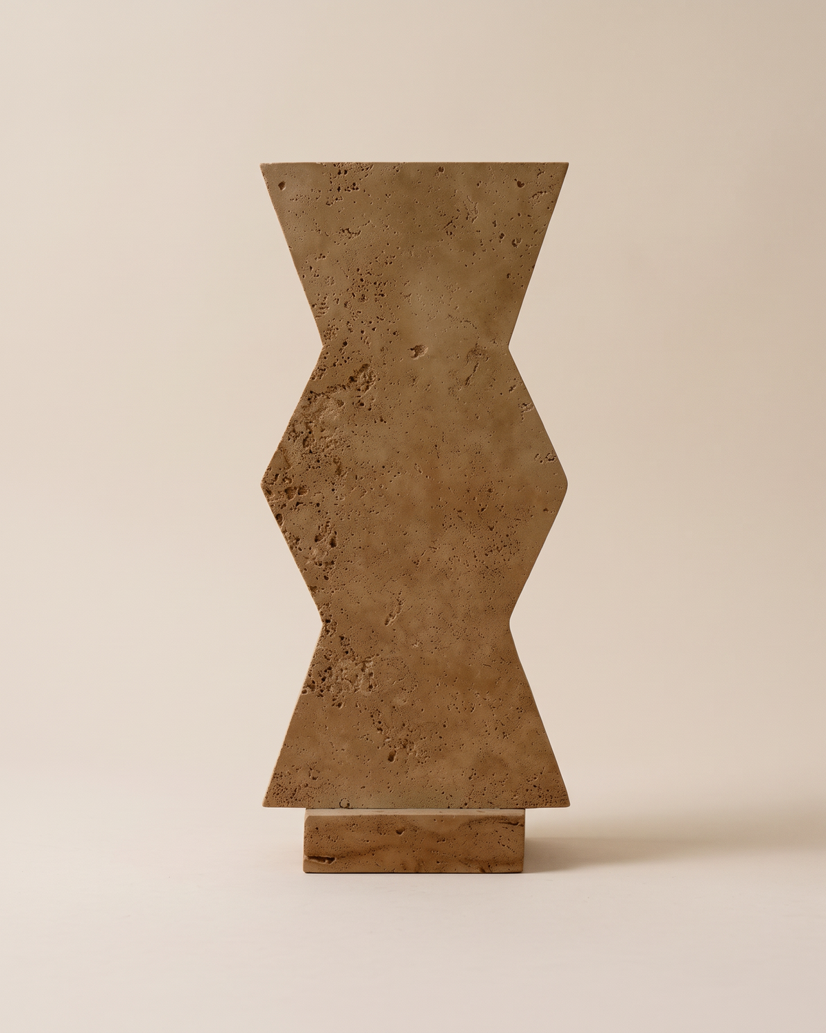 Travertine Zigzag Sculpture (One Piece) on a warm ivory studio background