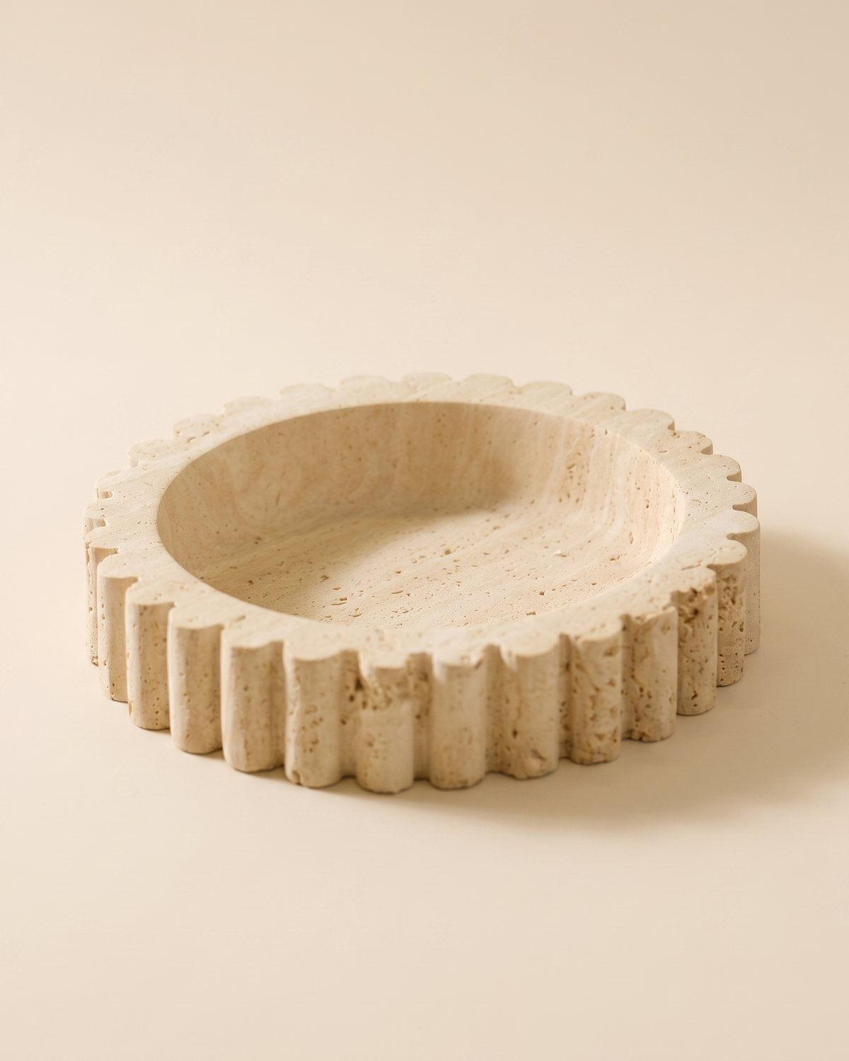 Travertine Sur Tray - cream travertine tray with scalloped fluted rim, ivory studio background