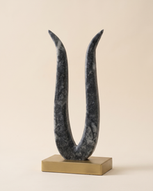 Tulip Decorative Object II - dark grey marble U form sculpture on brass base, ivory studio background