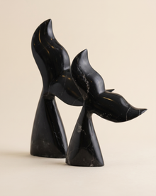 Whale Tail Decorative Object IV - two black marble whale tail sculptures, ivory studio background