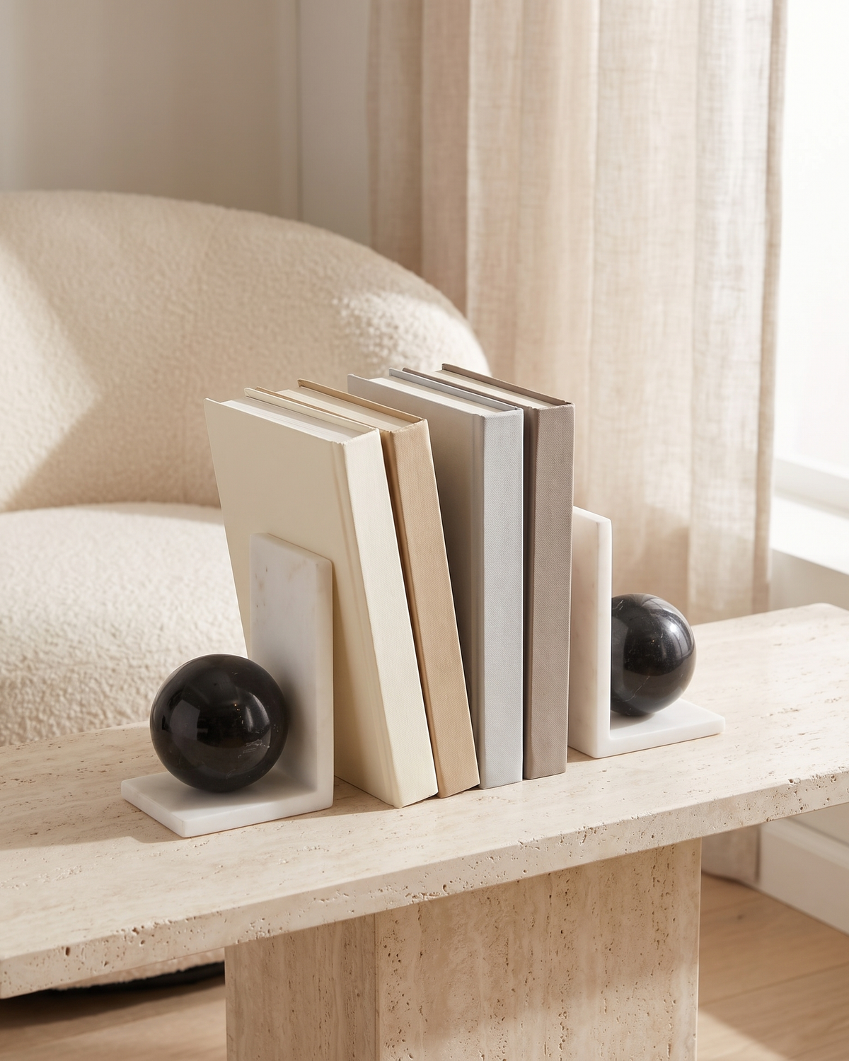 White Marble & Black Sphere Bookends - styled on a travertine console holding plain books