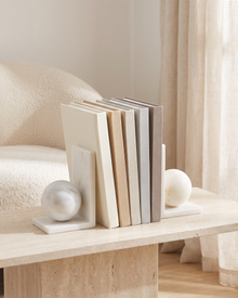 White Marble Sphere Bookends - styled on a travertine console holding plain books