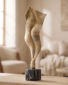 Wind Decorative Object Gold - styled on a warm beige console in a cosy interior